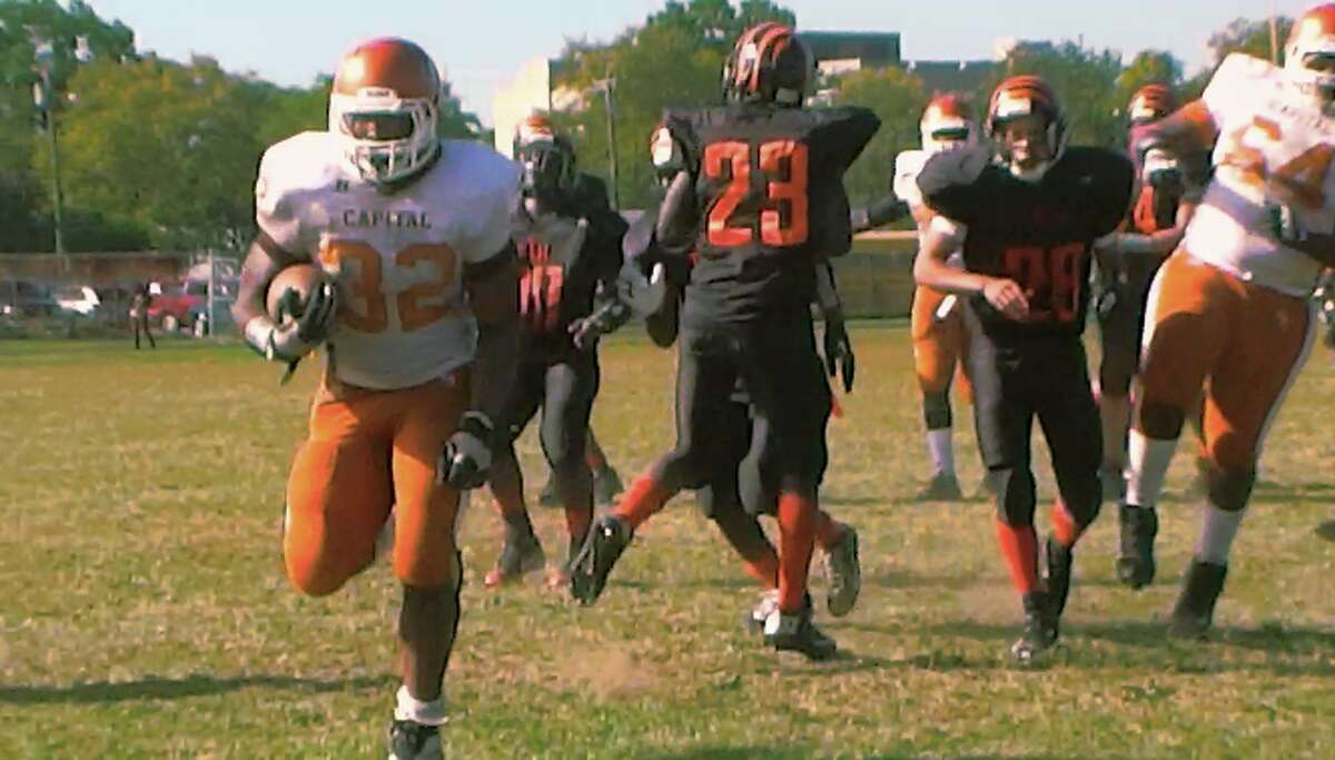 Capital Prep’s Mike Jones bursts through the middle for a 12-yard touchdown run in the final moments of a 27-18 victory over Bullard-Havens Saturday Oct. 12, 2013