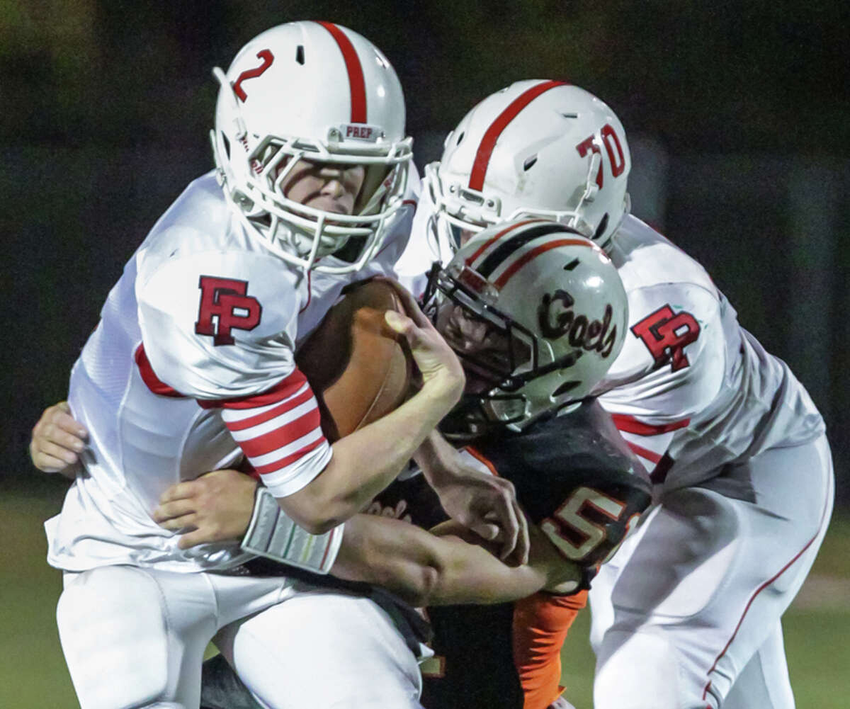 Fairfield Prep quarterback Colton Smith attempts to break free from a Shelton tackler Friday night.