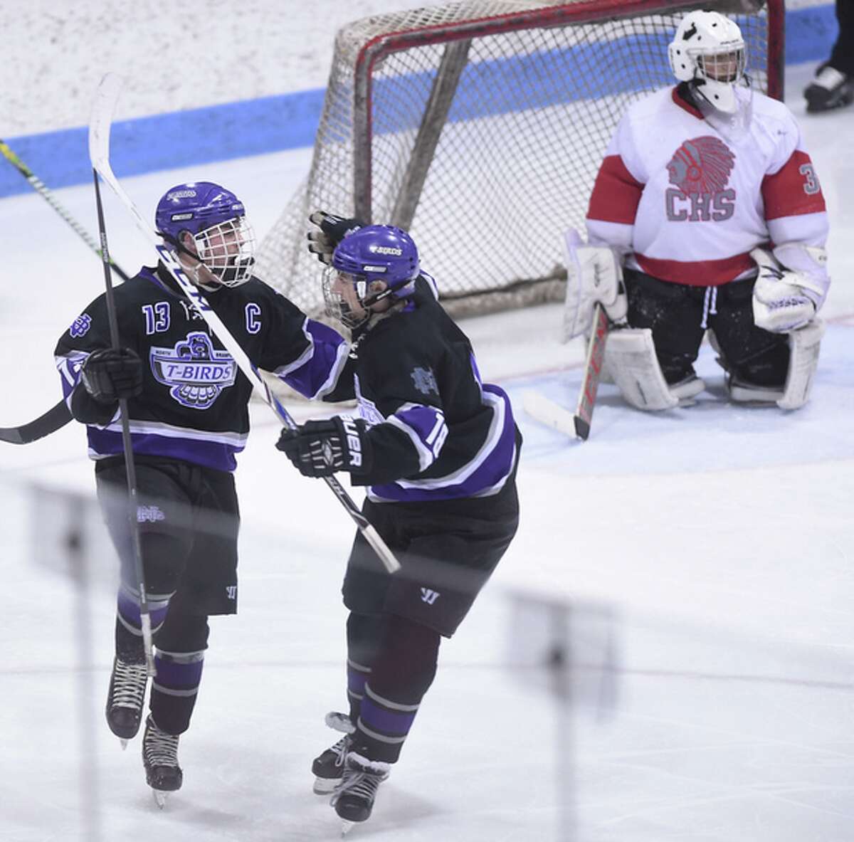 North Branford’s Alec Martone (left) celebrates with a teammate during the Division II semifinals at Ingalls Rink. (Photo Arnold Gold)
