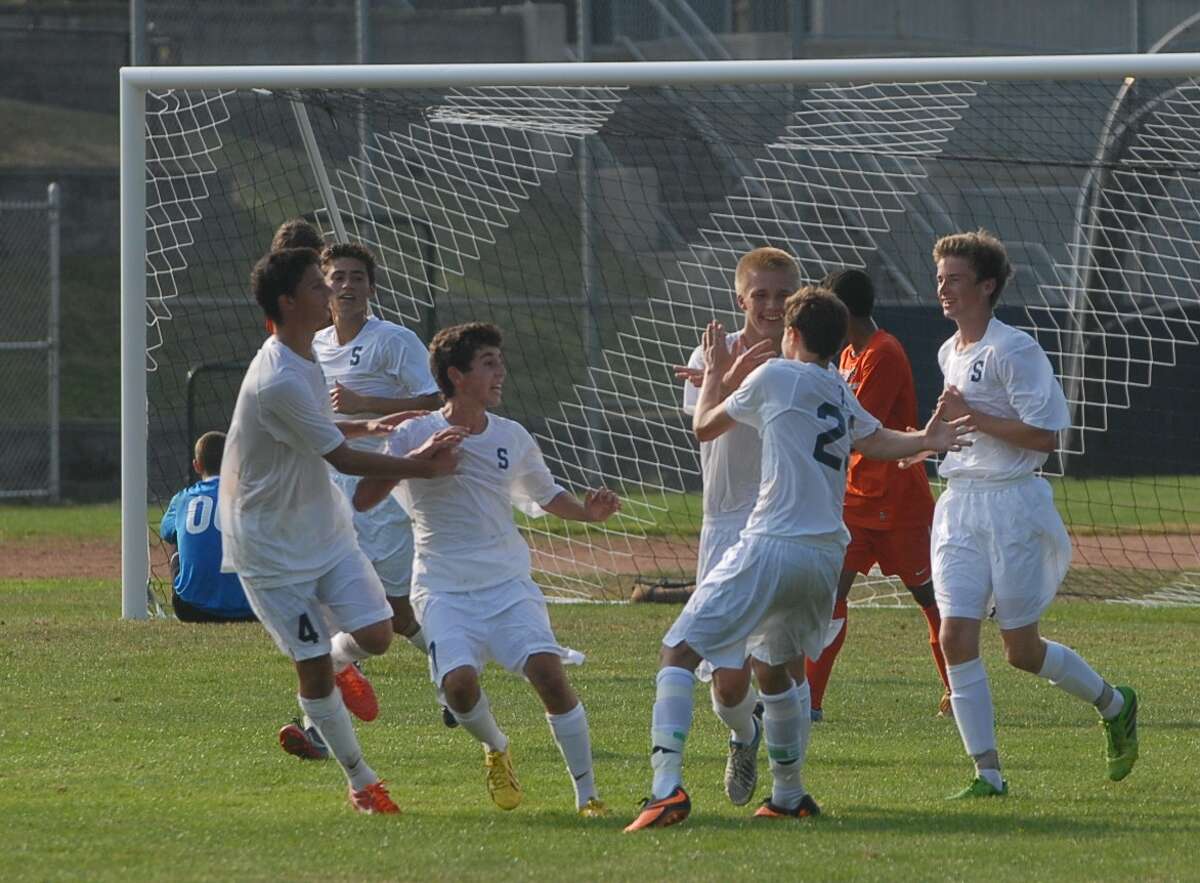The Staples boys’ soccer team celebrates a goal during a game earlier this season.