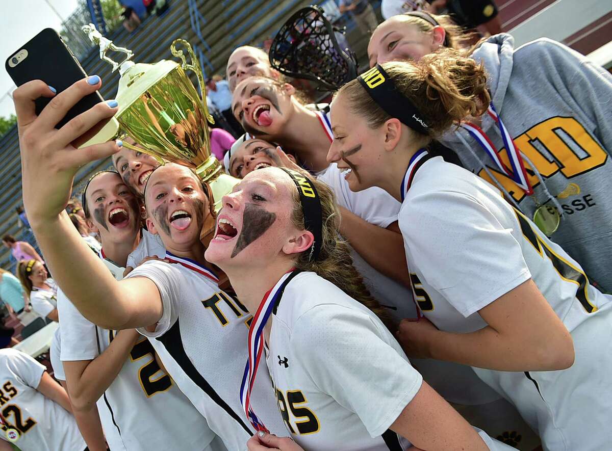 The Hand girls lacrosse team pose for a selfie with the SCC championship trophy after defeating Guilford, 18-6, Thursday, May 28, 2015, at Ken Strong Stadium at West Haven High School. (Catherine Avalone/New Haven Register)