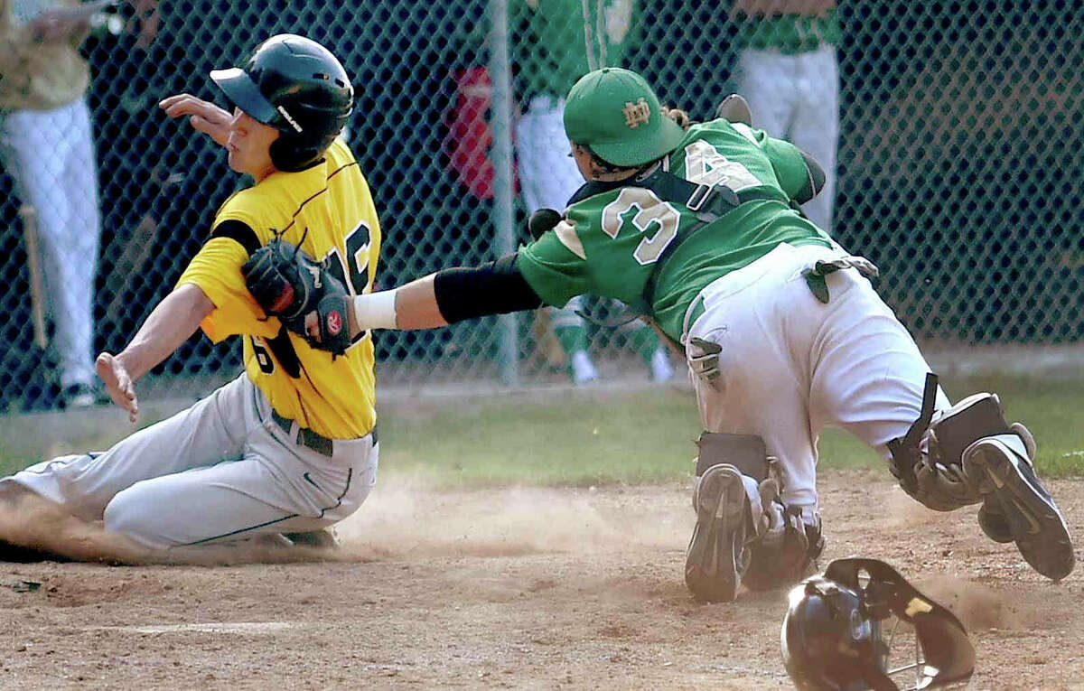 Catcher Ryan Muir of Notre Dame H.S. of West Haven puts the tag on Eli Oliphant of Amity H.S. slides into home plate during 4th inning baseball action at Amity High School n at Amity H.S. Thursday, May 21, 2015. (Peter Hvizdak – New Haven Register)