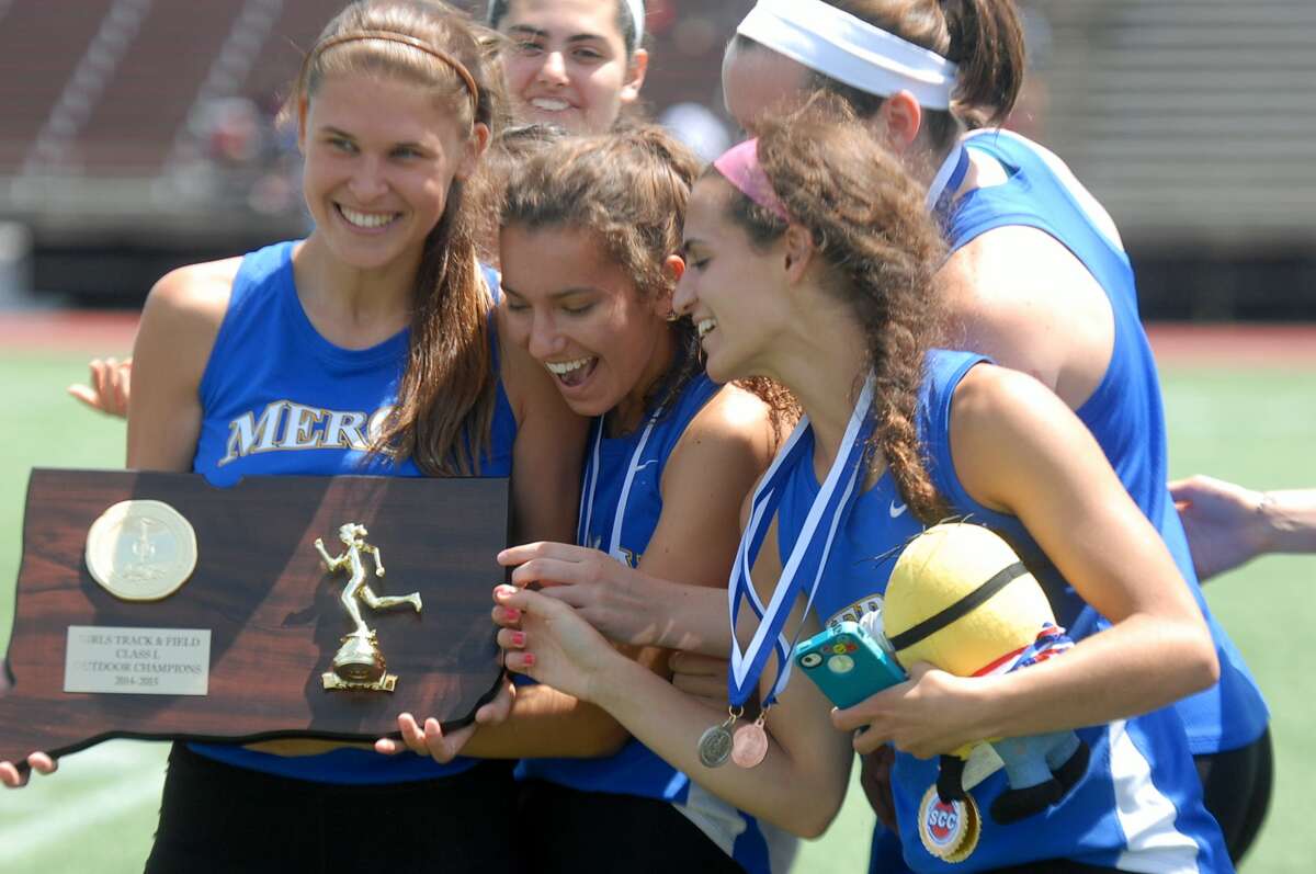 The Mercy High girls’ track team looks at their state title Wednesday afternoon.