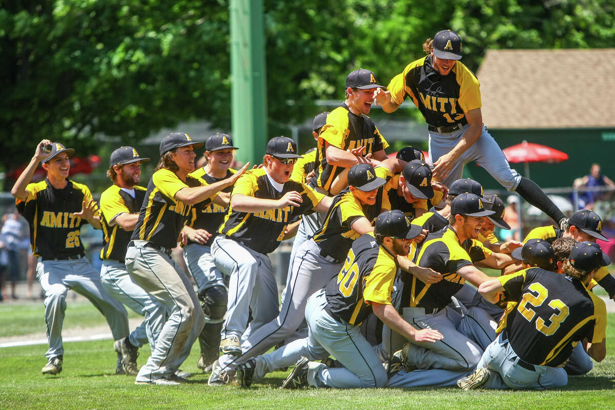 The Amity Spartans Baseball team celebrates its “Three-Peat” Class LL win over Staples of Westport Saturday at Palmer field in Middletown. (Photo John Vanacore)
