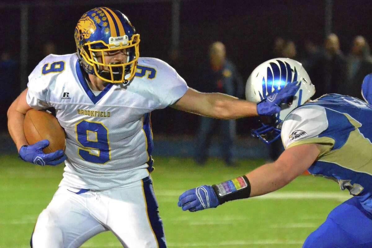 Brookfield’s Bobby Drysdale breaks a tackle vs. Newtown last year. (File photo by Pete Paguaga)