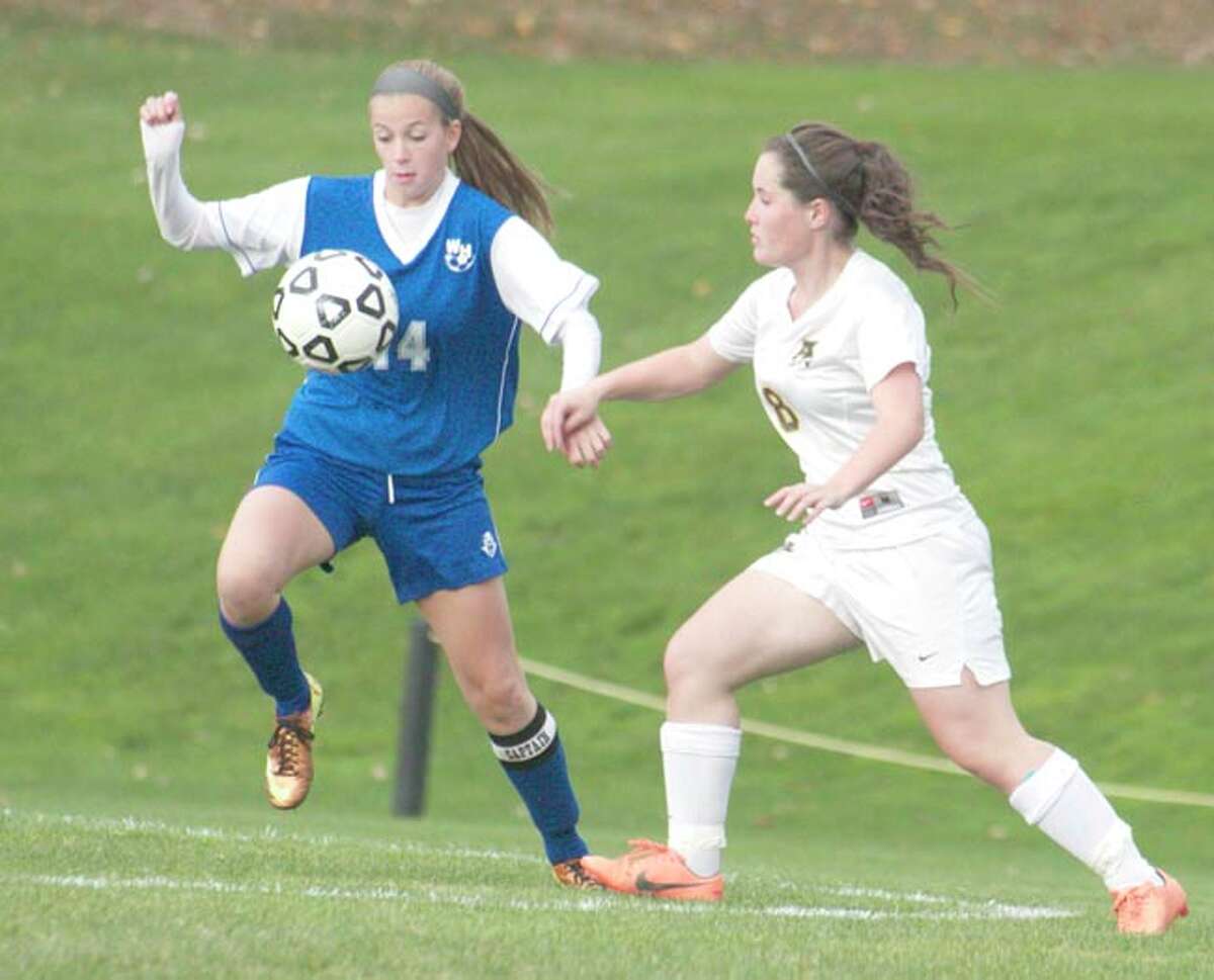 Photo by Russ McCreven/ Amity’s Cassie Giza (8) battles West Haven’s Allyson Hemstock for the ball during Wednesday’s game.