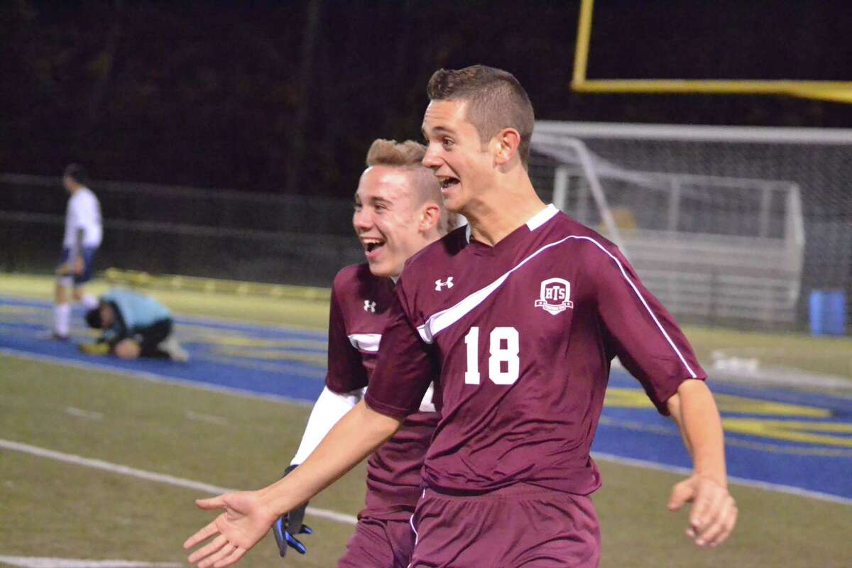 Torrington’s Griffin Pelkey celebrates with teammates Ethan Barbieri after he scores his second goal of the game in Torrington’s 7-0 win.