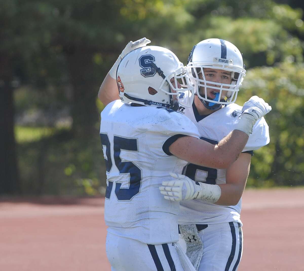 Seniors Patrick Lesch and Jack Greenwald celebrate a score against Westhill earlier in the season.