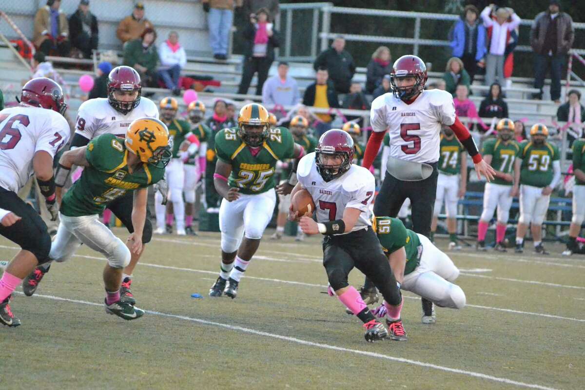 Torrington’s Tyler Marens runs up field during the Red Raiders 41-21 loss to Holy Cross. Marens ran for 82-yards.