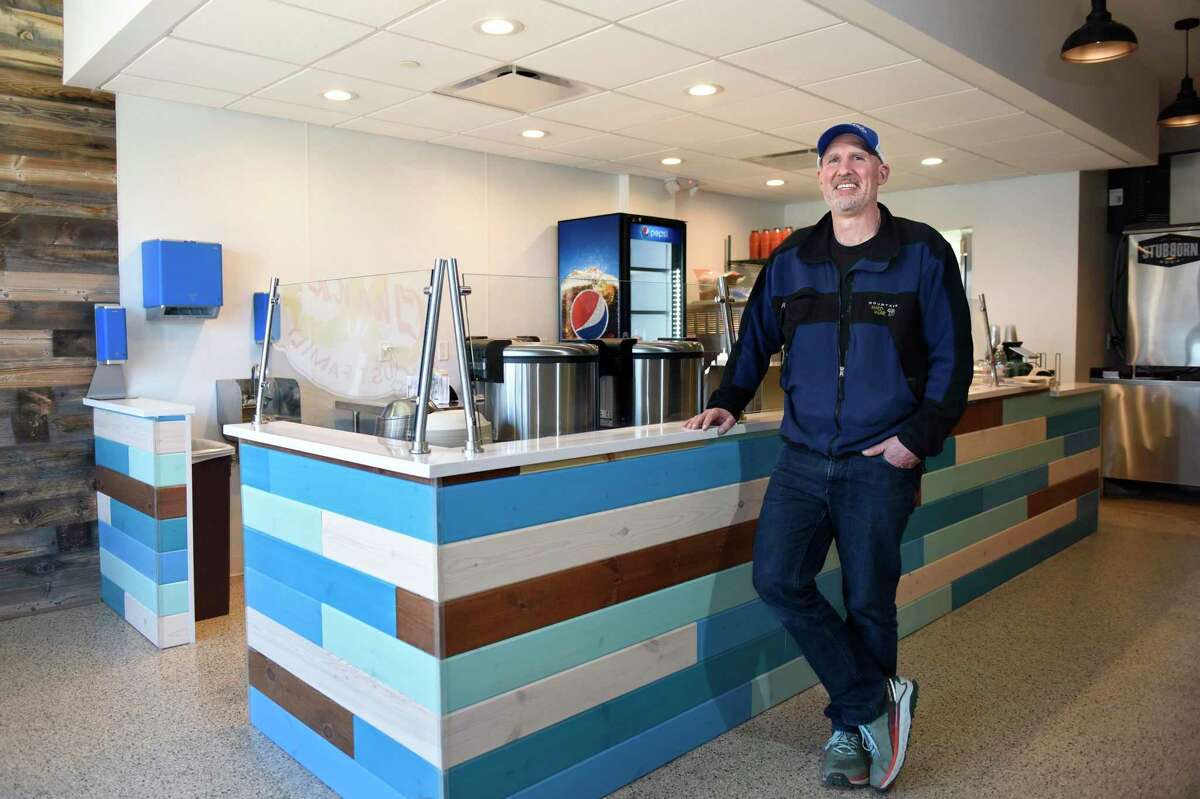 Franchise owner Jamie Darnow poses at the new Island Fin Poké in the Cos Cob section of Greenwich, Conn. Wednesday, April 20, 2022. The fast casual restaurant is known for its build-your-own poké bowls with a variety of choices for the bowl's base, protein, toppings, mix-ins, and sauces.