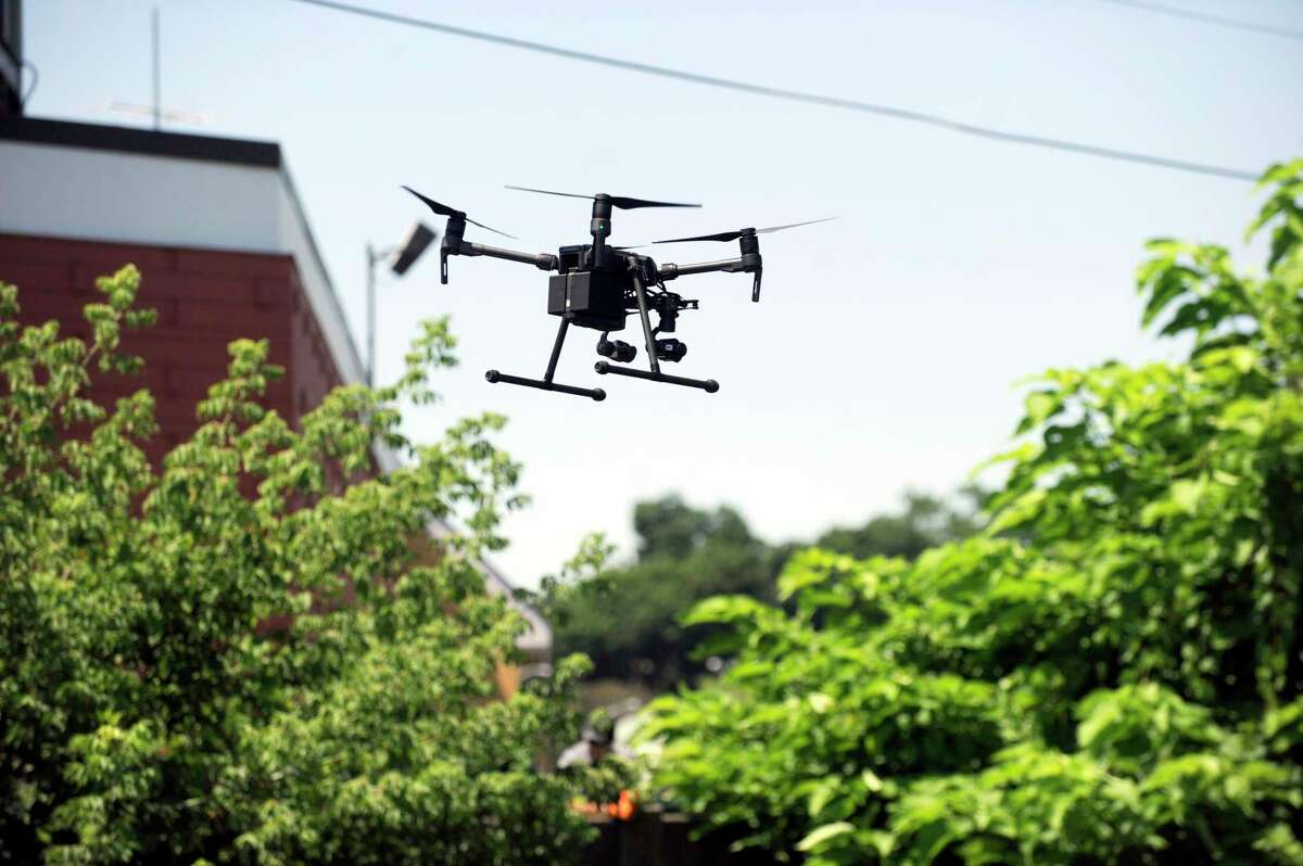 A Danbury Fire Department drone is activated around the area where firefighters search the banks of the Still River in July, 2018.