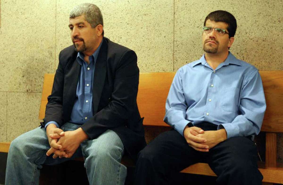 Mohammed “Moe” Omar’s brothers Joe Omar (left) and Hasan Omar sit outside the courtroom. Hasan Omar testified that Moe Omar came to the U.S. from Jordan in 1985 and that running the store, which he opened in 2006, was his dream.