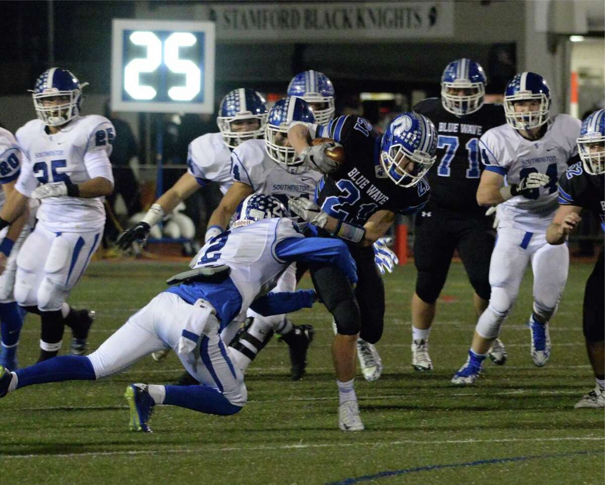 Darien’s Shelby Grant is tackled by a host of Southington defenders during the Blue Wave’s 49-7 victory (Photo