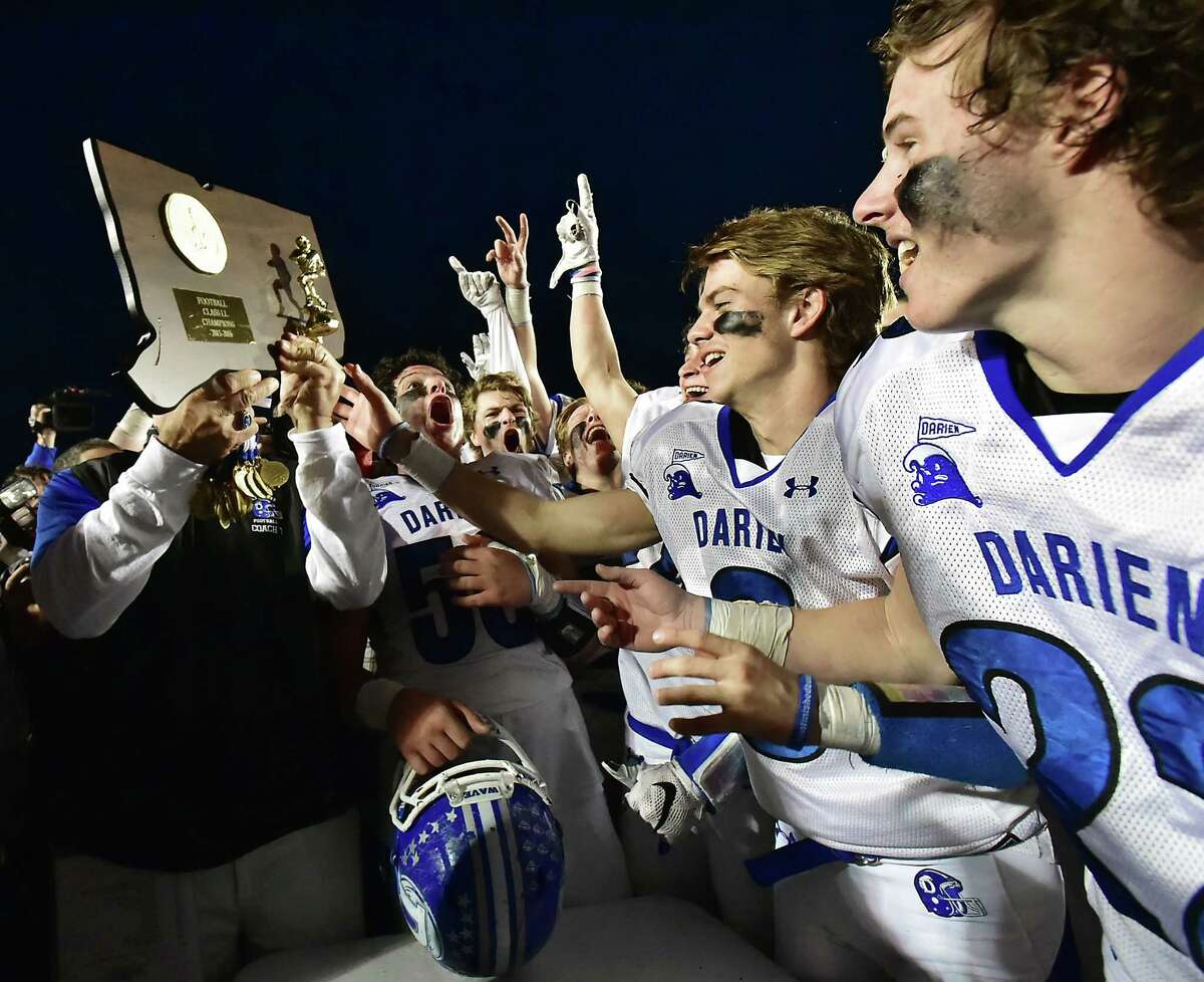 The Darien Wave celebrate after defeating the Shelton Gaels, 39-7, for the Class LL state football championship, Saturday, December 12, 2015, at New Britain Stadium at Willowbrook Park in New Britain. (Catherine Avalone/New Haven Register)