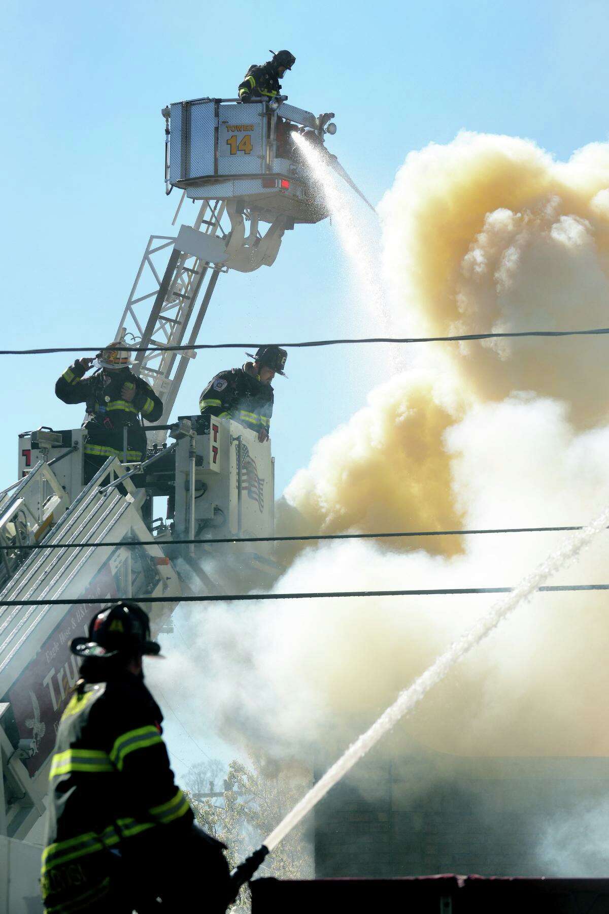 Firefighters from Seymour and other surrounding towns at the scene of a working fire in a building at the intersection of Main St. and Bank St., in Seymour, Conn. April 20, 2022.