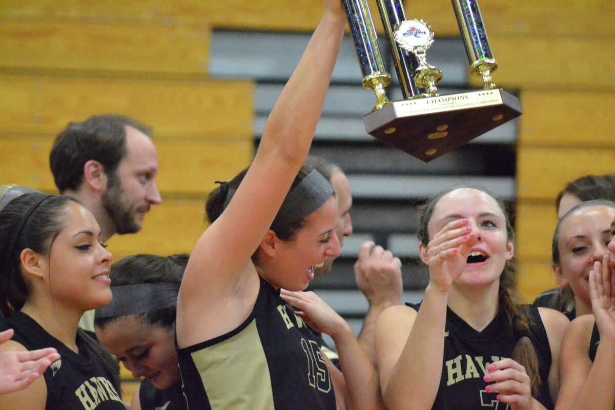 Woodland’s Brianna Pacileo celebrates with the NVL championship trophy after the Hawks beat Torrington 3-1.