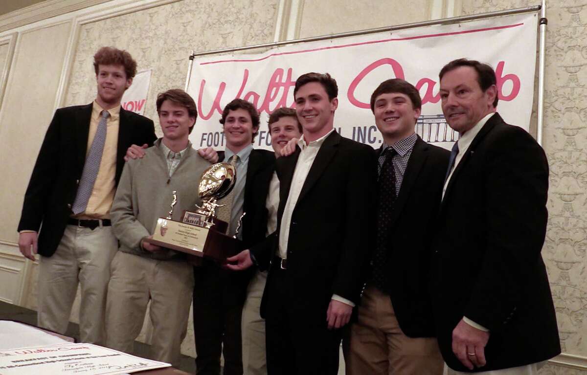 Darien’s football captains with the Walter Camp Football Foundation’s Kelly Award given to the No. 1 team in the New Haven Register Top 10 poll. From left Tim Graham, Colin Minicus, Christian Trifone, Hudson Hamill, Bobby Trifone, Mark Evanchick and coach Rob Trifone. (Photo Sean Patrick Bowley)