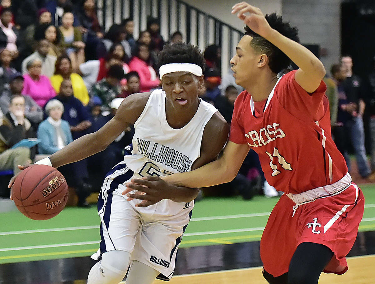 Hillhouse sophomore guard Byron Breland III drives as Cross junior guard Jayden Valderamma defends in a 78-76 overtime win for the Academics, Wednesday, January 27, 2016, Floyd Little Athletic Center in New Haven. (Catherine Avalone/New Haven Register)