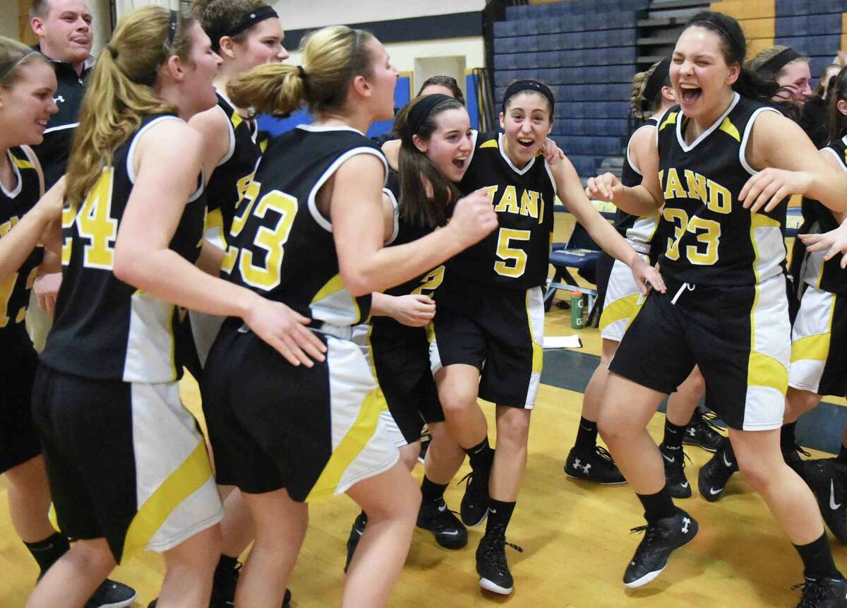 Hand’s girls basketball team reacts after winnin the SCC girls basketball championship over Mercy Feb. 24 at East Haven. (Peter Hvizdak – New Haven Register)