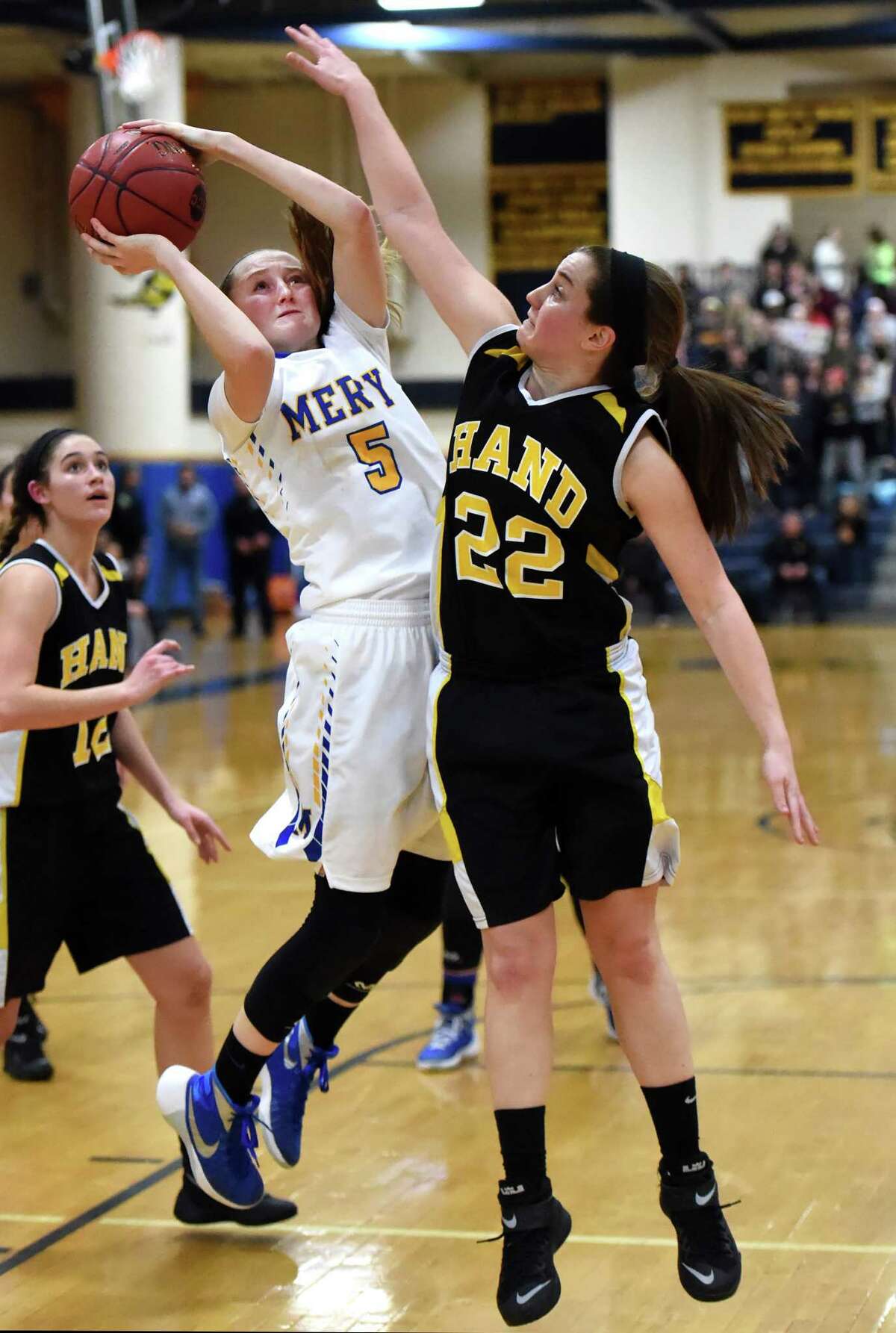 Isabella Santoro of Mercy High School has her shot blocked by Paula Materin of Hand H.S. during the fourth guarter of the SCC girls basketball championship at East Haven High School Tuesday evening, February 23, 2016. (Peter Hvizdak – New Haven Register)