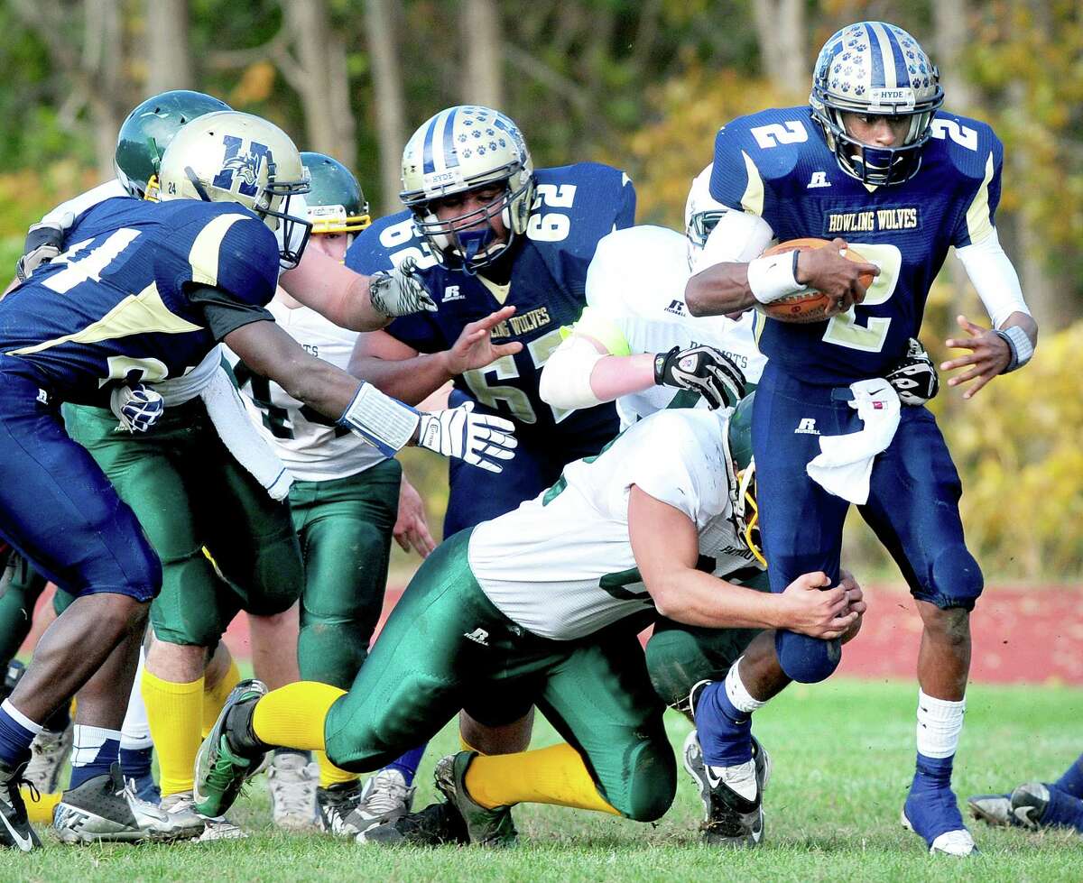 Arnold Gold – Register Hyde quarterback Dwayne Hunter-Parker tries to break a tackle against CoventryWindham Tech/Bolton, which beat Hyde 21-18 Saturday.
