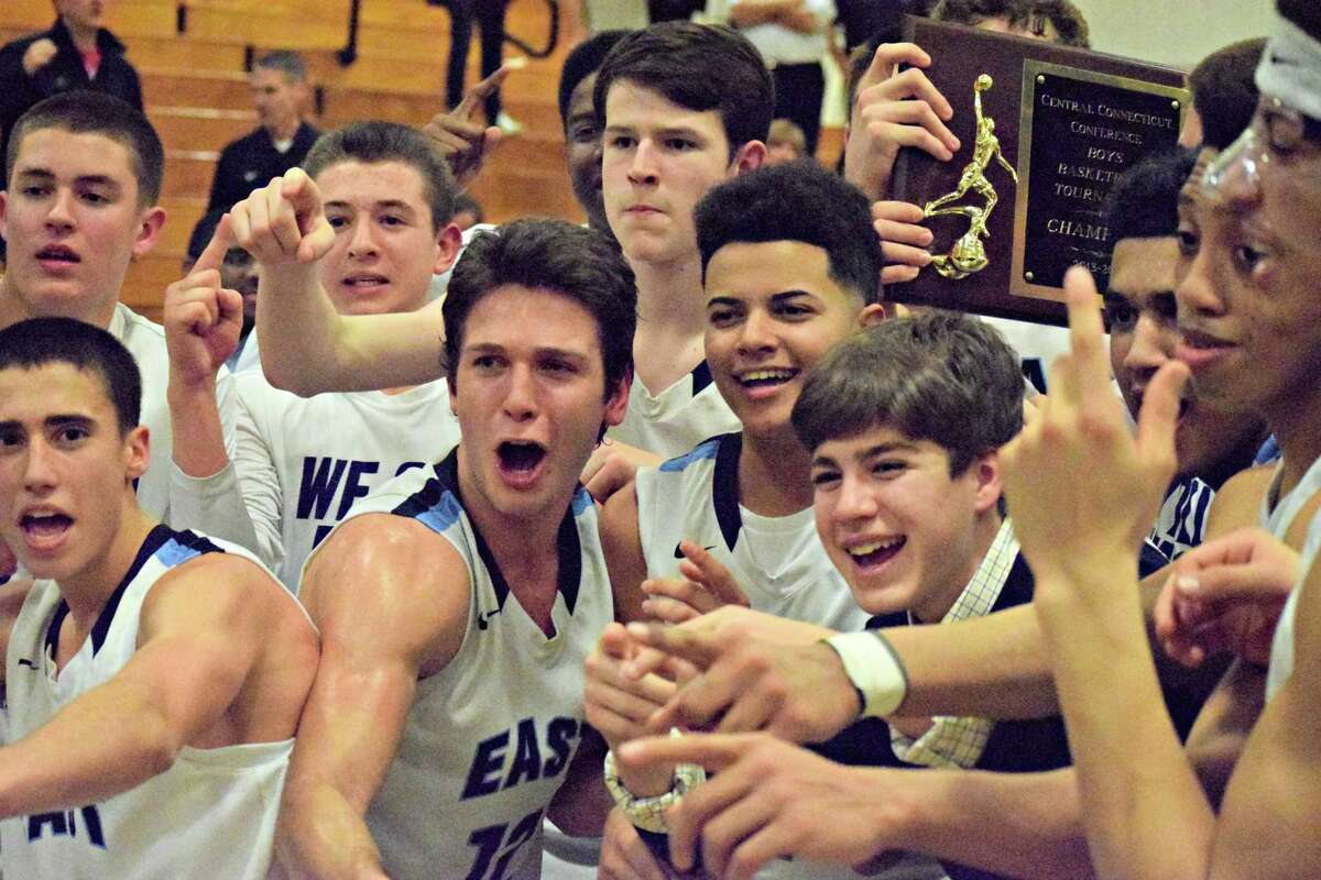 East Catholic celebrates with its first-ever CCC tournament championship trophy. Derek Turner/GameTimeCT