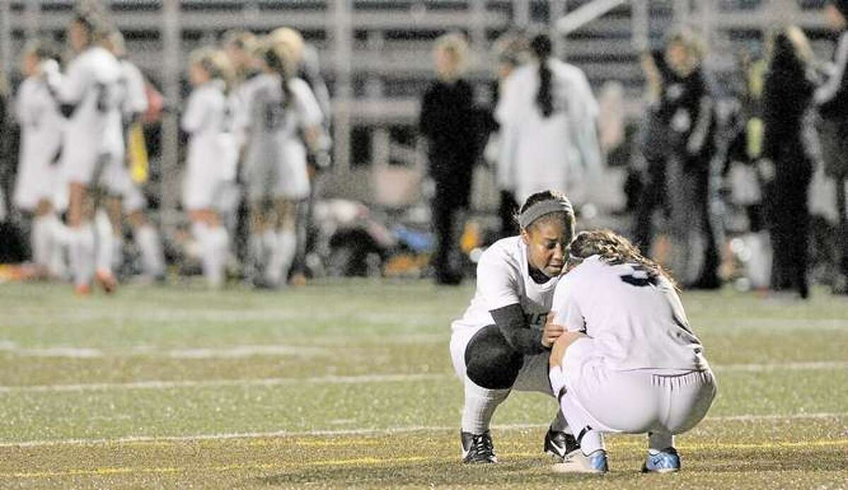 Middletown senior Rajeen Mayor consoles teammate Marissa Aldieri following their 2-1 loss to Bunnell-Stratford in the First Round of the CIAC Class L soccer tournament Monday evening at Rosek-Skubel Stadium at MHS. Catherine Avalone — The Middletown Press