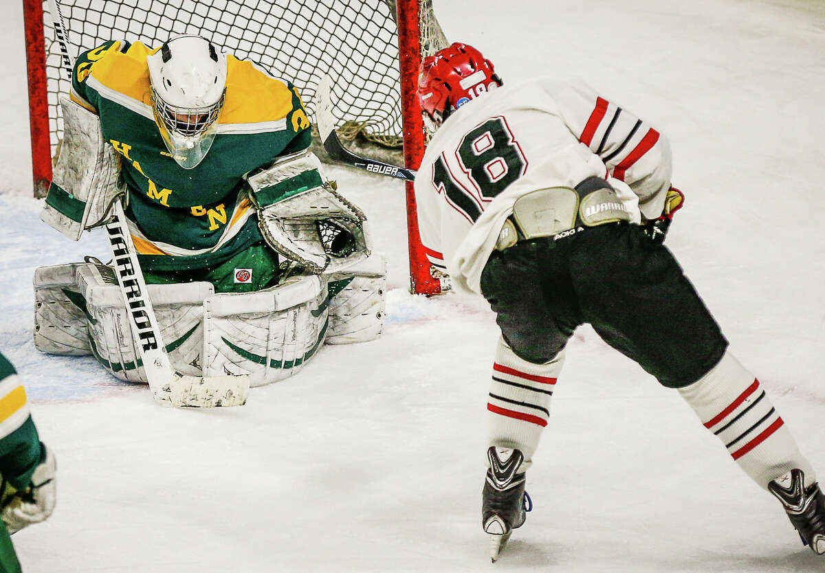 Hamden goaltender Steven Turner Makes a glove save off the shot of Greenwich’s Colin Kelly during the Green Dragon’s 3-2 win over Greenwich Saturday afternoon.-John Vanacore/Register