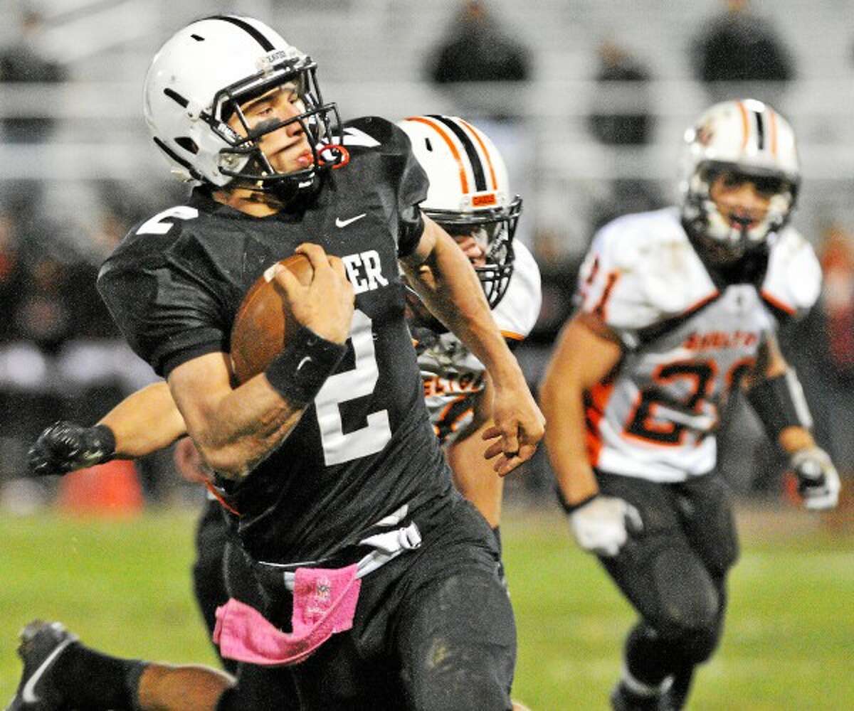 Xavier senior quarterback Joe Carbone busts through Shelton defense Friday night at Palmer Field. The Xavier Falcons defeated the Shelton Gaels 15-12 in the final seconds of the game. Catherine Avalone – The Middletown Press