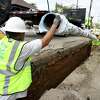 Workers with East Bay Municipal Utility District install new water pipe in Oakland in 2021. The district may limit the amount of water people can use.