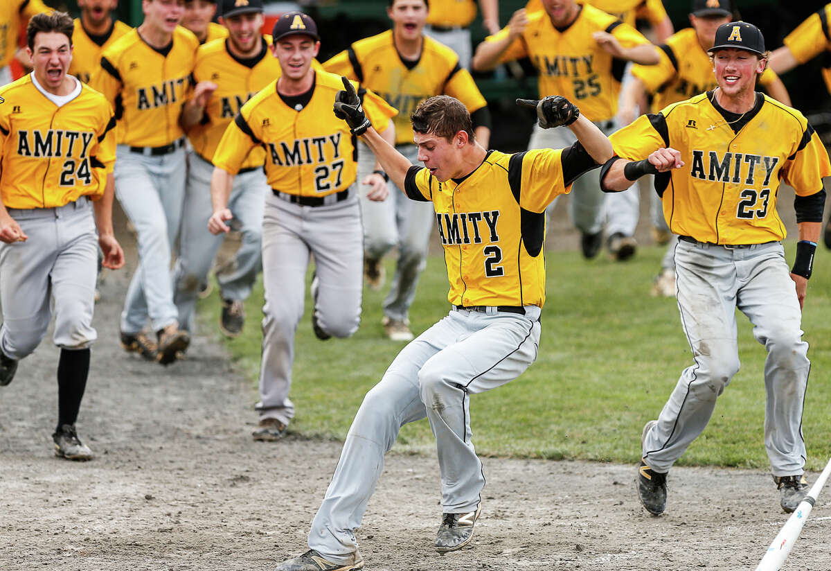 Chris Winkel comes home with the winning run as Amity walked off with its fourth-consecutive Class LL championship in a 4-3 victory over Fairfield Warde Saturday at Palmer Field.