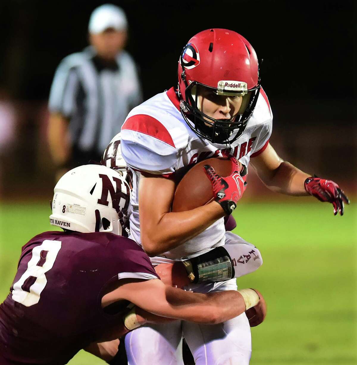 Cheshire junior wide receiver Tommy Wnuck fights off North Haven’s Tom Dodge (8) and Zack Orth (33) in a 24-21, on opening night of high school football, Friday, September 9, 2016, at Mike Vanacore Field at the North Haven Athletic Complex. (Catherine Avalone/New Haven Register)