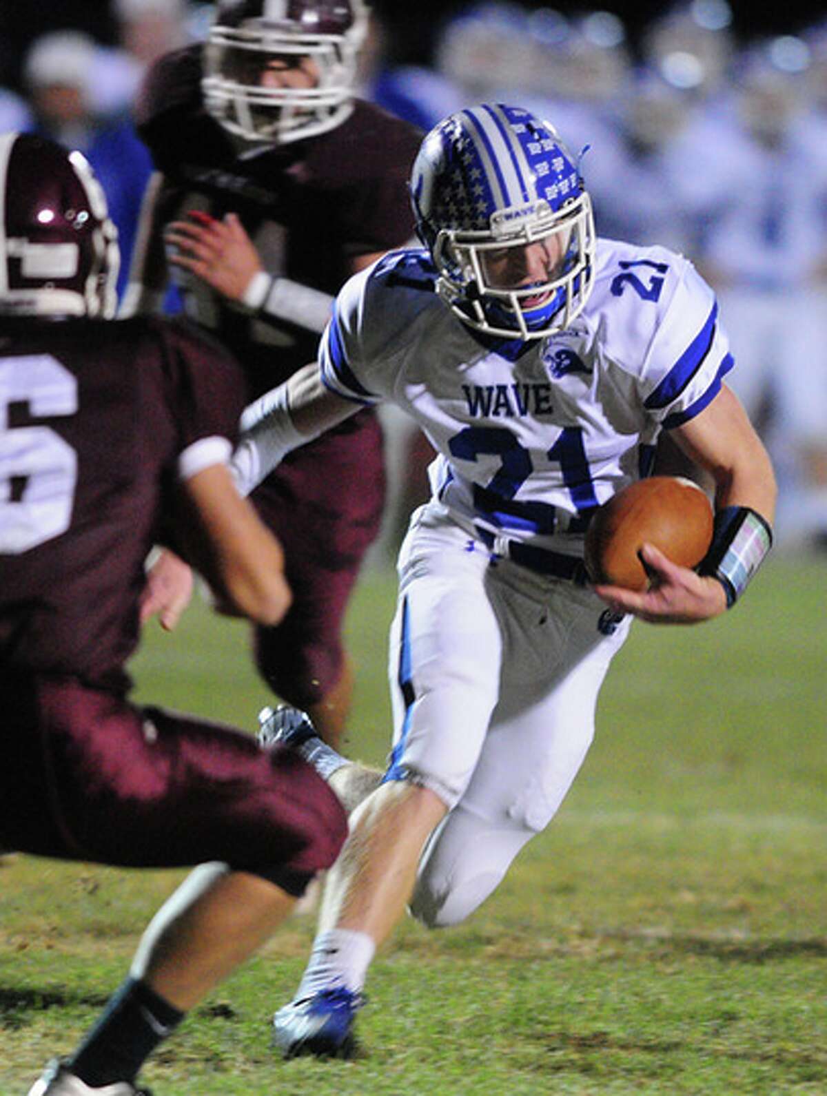 Darien’s Nick Lombardo runs past North Haven defenders in the Blue Wave’s 36-27 victory Friday at Vanacore Field (Photo by Arnold Gold)