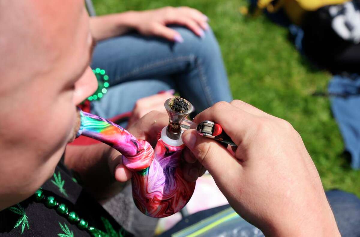 Brice Page, 28, of Manteca, lights up as the 4/20 festivities make a triumphant return following a two-year hiatus due to the pandemic.