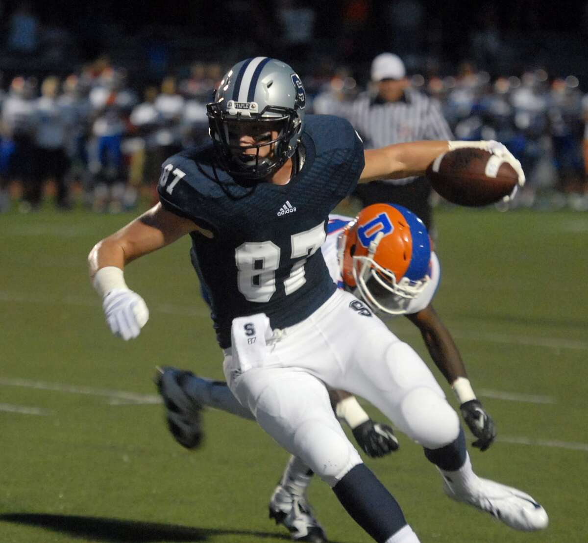 Staples’ Ryan Fitton makes his way to the end zone in the first quarter of play against Danbury.