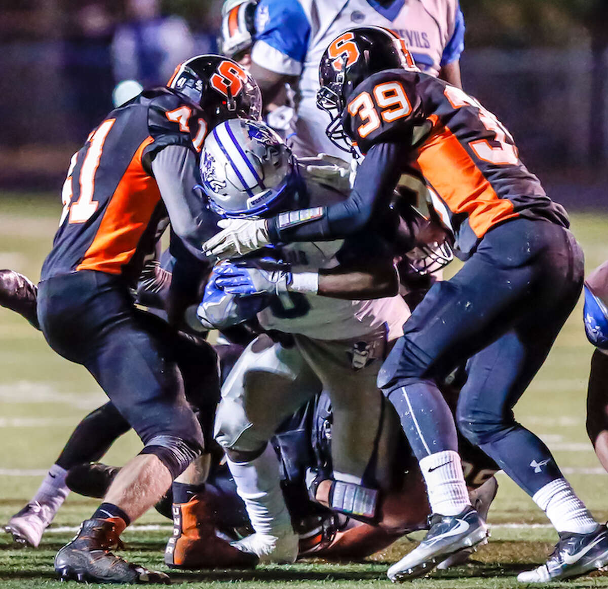 West Haven’s Anthony Godfrey battles against a tough Shelton defense during their SCC Division 1 matchup Friday evening.-John Vanacore/New Haven Register