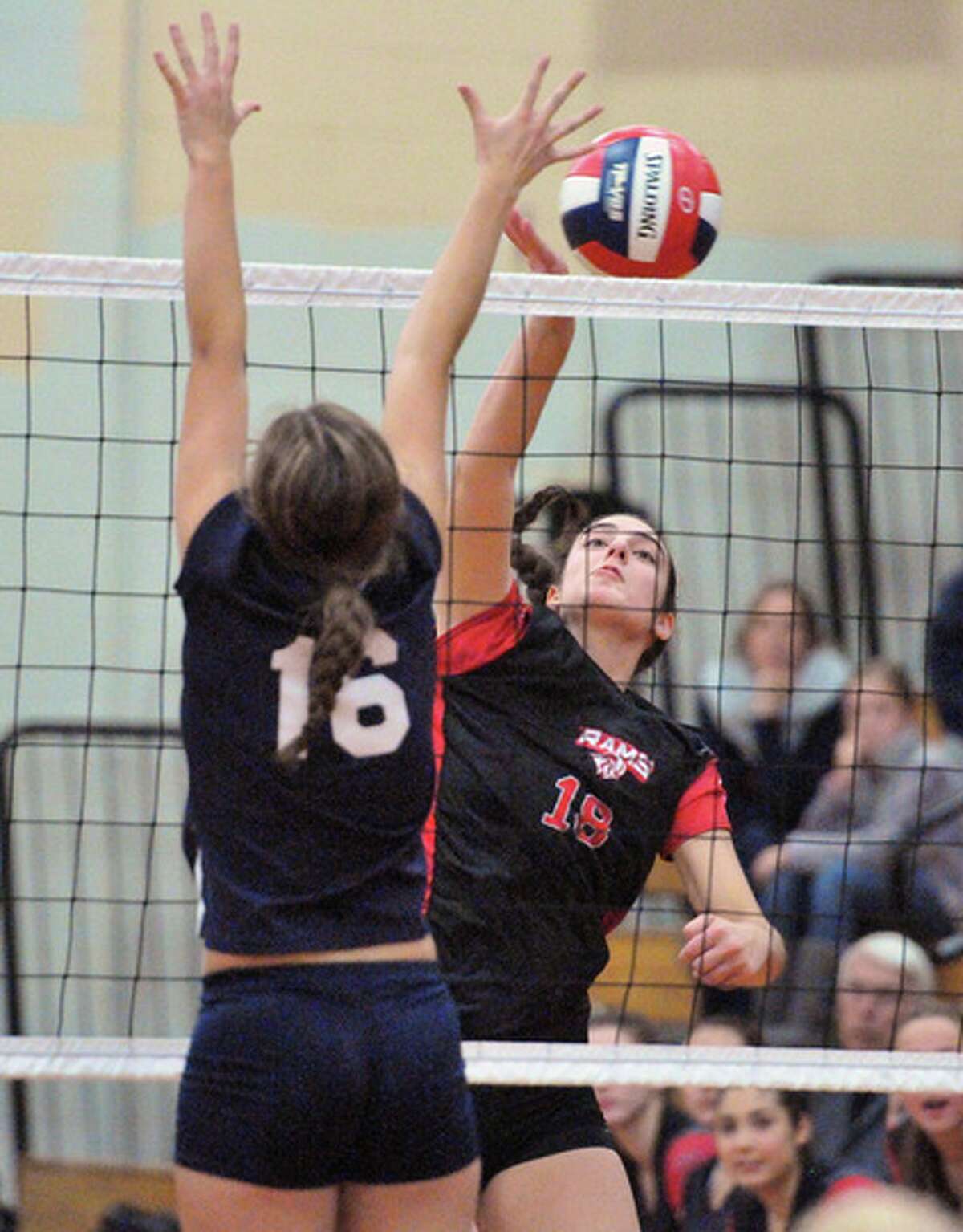(Peter Casolino — New Haven Register) Cheshire’s Jillian Haberli spikes over Staples Makaela O’Kelly during the second set during the CIAC Class LL Championship Volleyball Championship game. pcasolino@NewHavenRegister