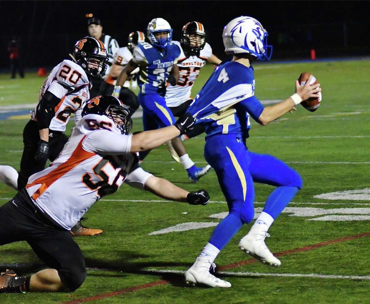 Newtown’s Justin Dunn gets hit from behind by Shelton’s Michael Casinelli. The tackle caused a fumble that was picked up by Jack Carr (Photo via Laxworm.com)