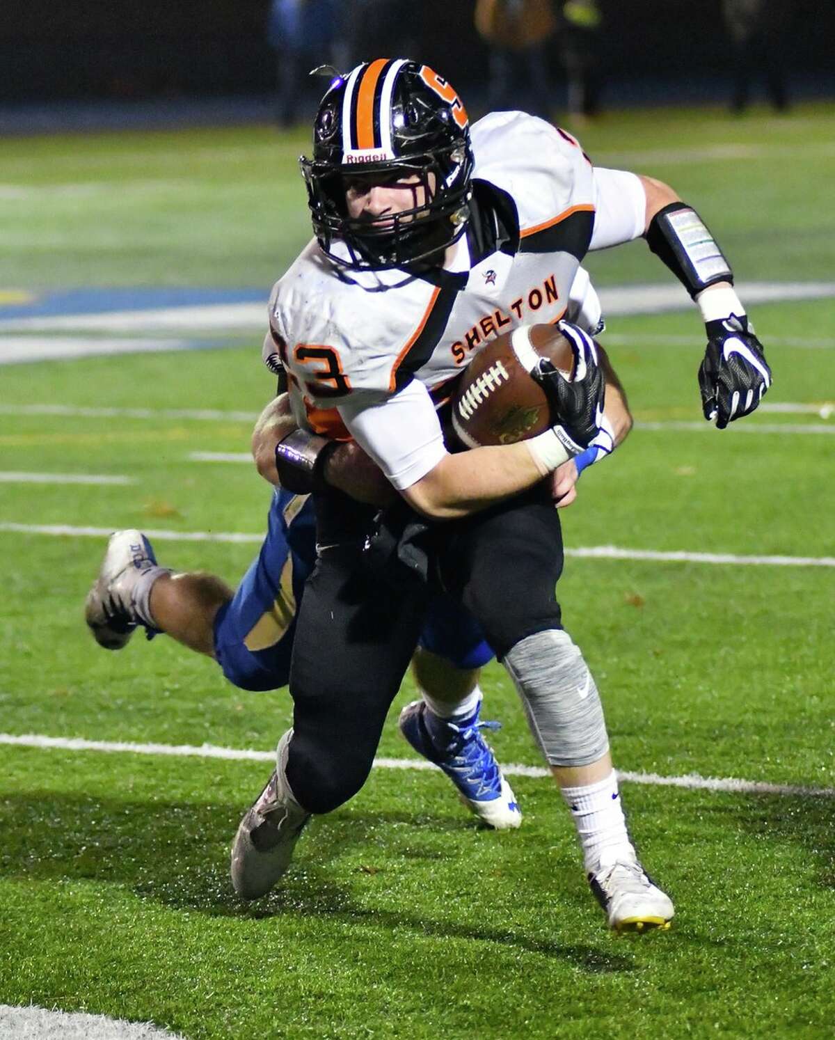 Ronnie Rich of Shelton breaks a tackle in the first half of the Gaels’ 55-21 win over Newtown (Photo via Laxworm.com)