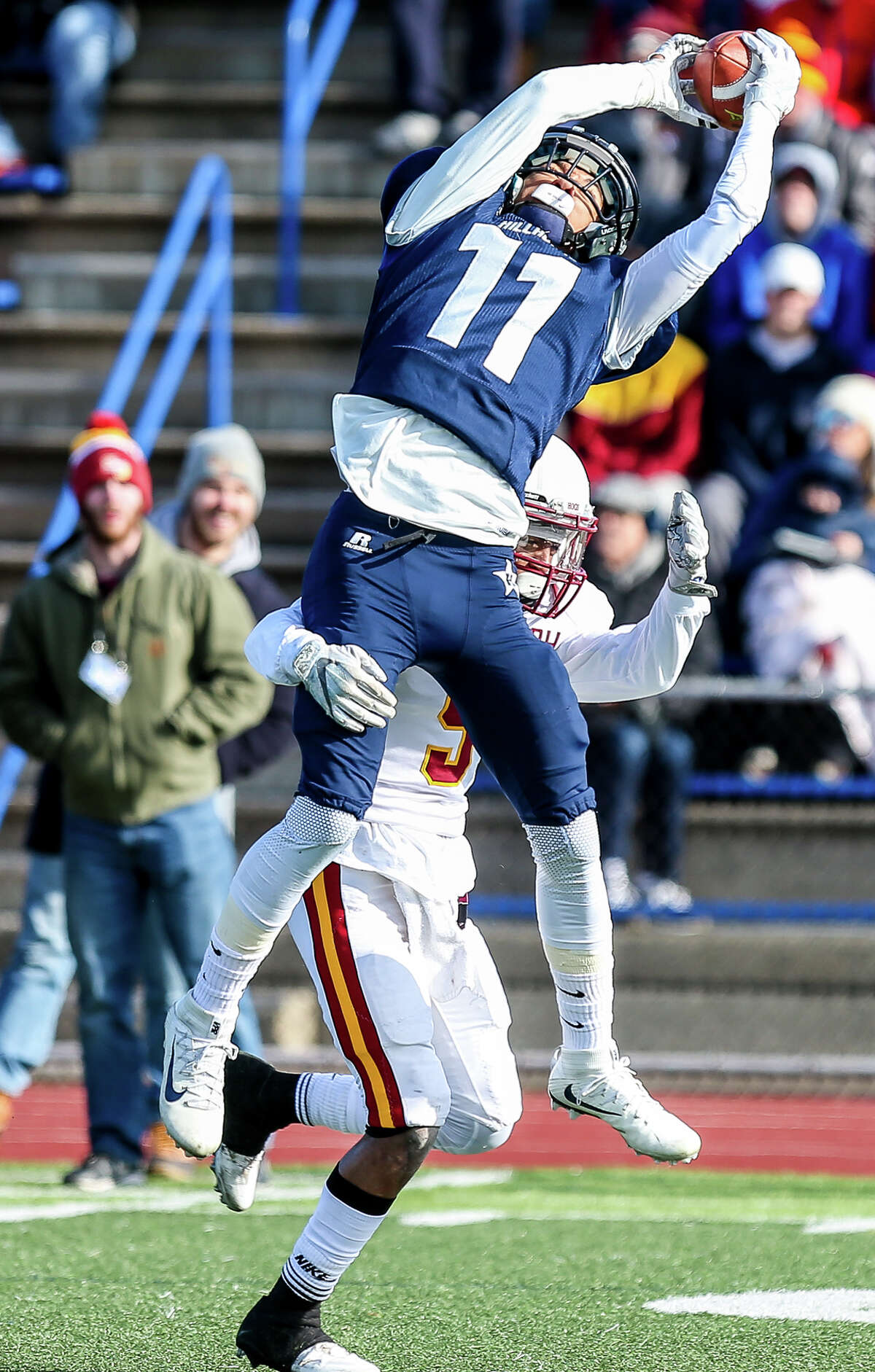Hillhouse Academic Chase Kinzley (11) goes up for a reception over the top of St Joseph’s Robbie Miller during Hillhouse’s 42-21 win for the CIAC Class M State title.-John Vanacore/New Haven Register