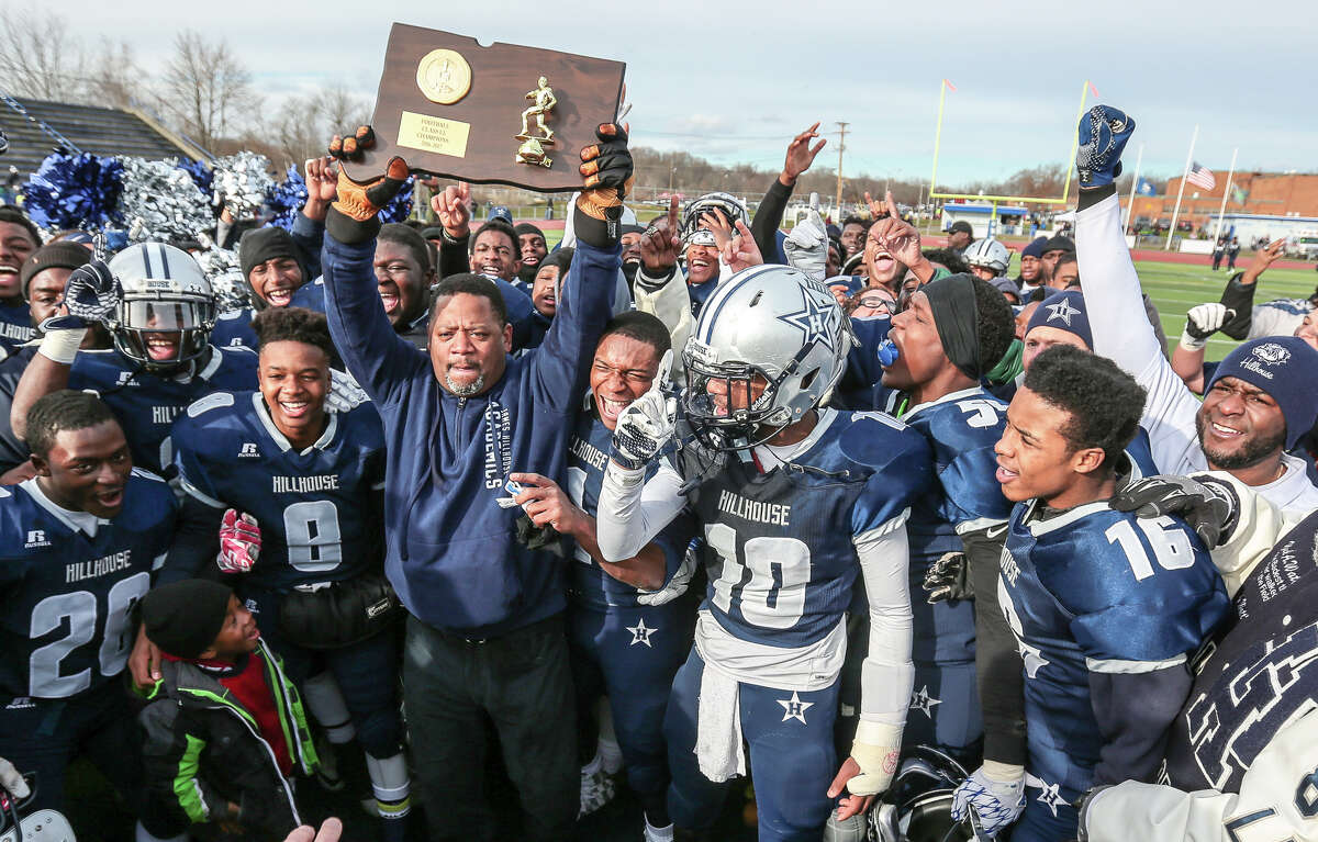 Hillhouse football coach Reggie Lytle and his Academics team celebrate their 42-21 win over the St Joseph Cadets Saturday for the CIAC Class M Championship title in West Haven.-John Vanacore/New Haven Register