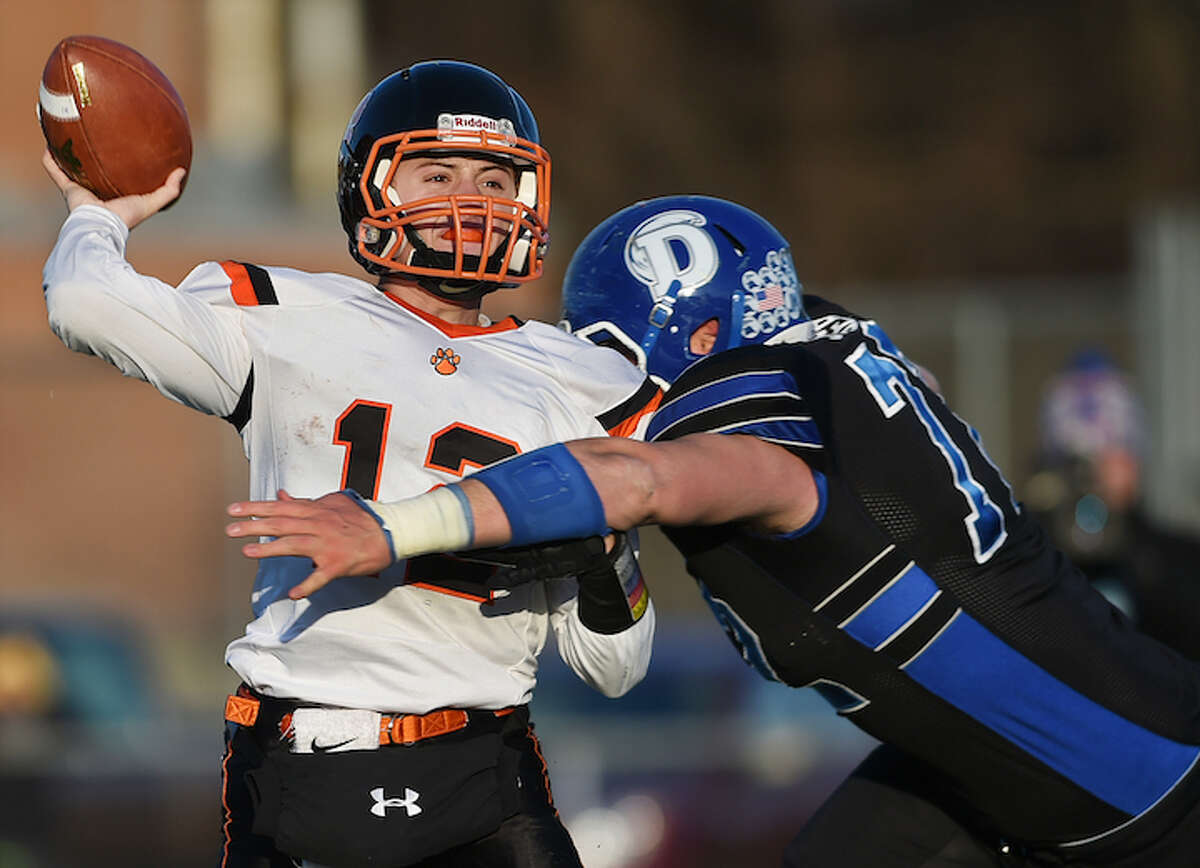 Darien’s Andrew Stueber sacks Ridgefield quarterback Drew Fowler in the Class LL championship game Saturday at Ken Strong Stadium. Darien won 28-7 for back-to-back titles. (Catherine Avalone/New Haven Register)