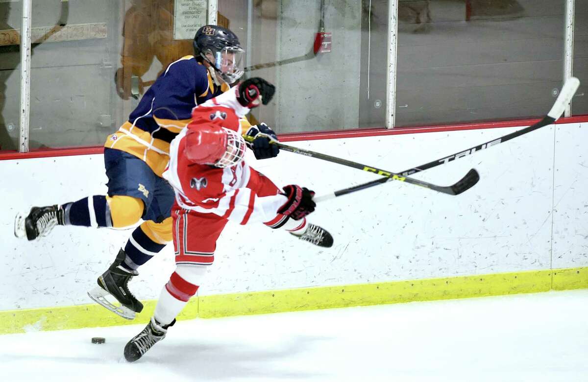 Mike Dogoto (left) of East Haven and Liam Killea of Cheshire collide in the first period at Wesleyan University in Middletown on 1/2/2017. Photo by Arnold Gold/New Haven Register