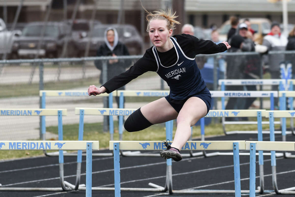 Meridian's Emma Bates competes in hurdles during a track meet against Clare High School Wednesday, April 20, 2022 at Meridian Early College High School.