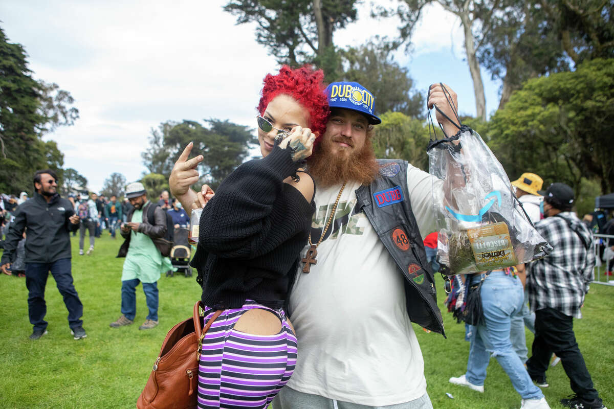 A couple poses for a photograph at the 420 Hippie Hill event in Golden Gate Park in San Francisco, Calif.  on April 20, 2022.