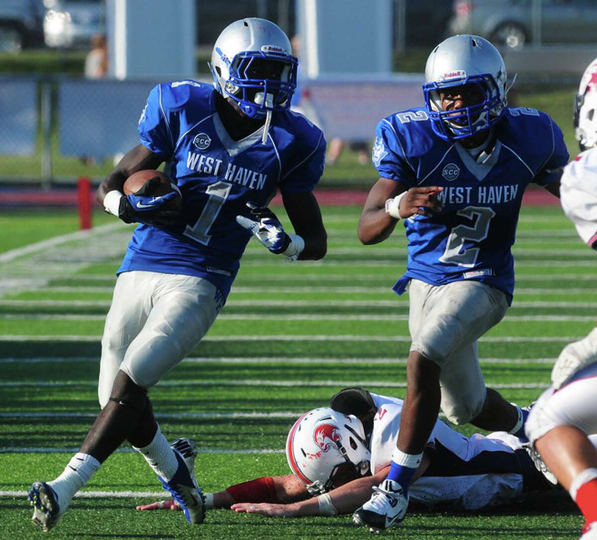 Ervin Philips (1) looks for running room for West Haven earlier this season. (Arnold Gold / Register)
