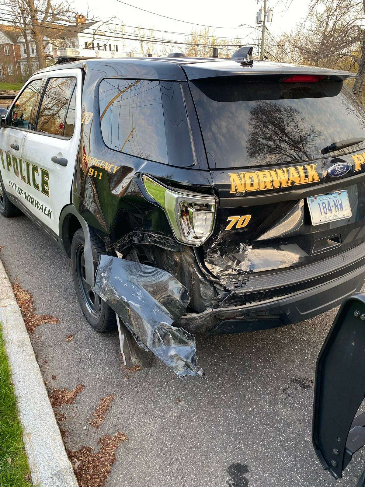 Authorities said officers were investigating a crash near the Norwalk Green in Norwalk, Conn., on Wednesday, April 20, 2022, when two cruisers were struck by another vehicle.