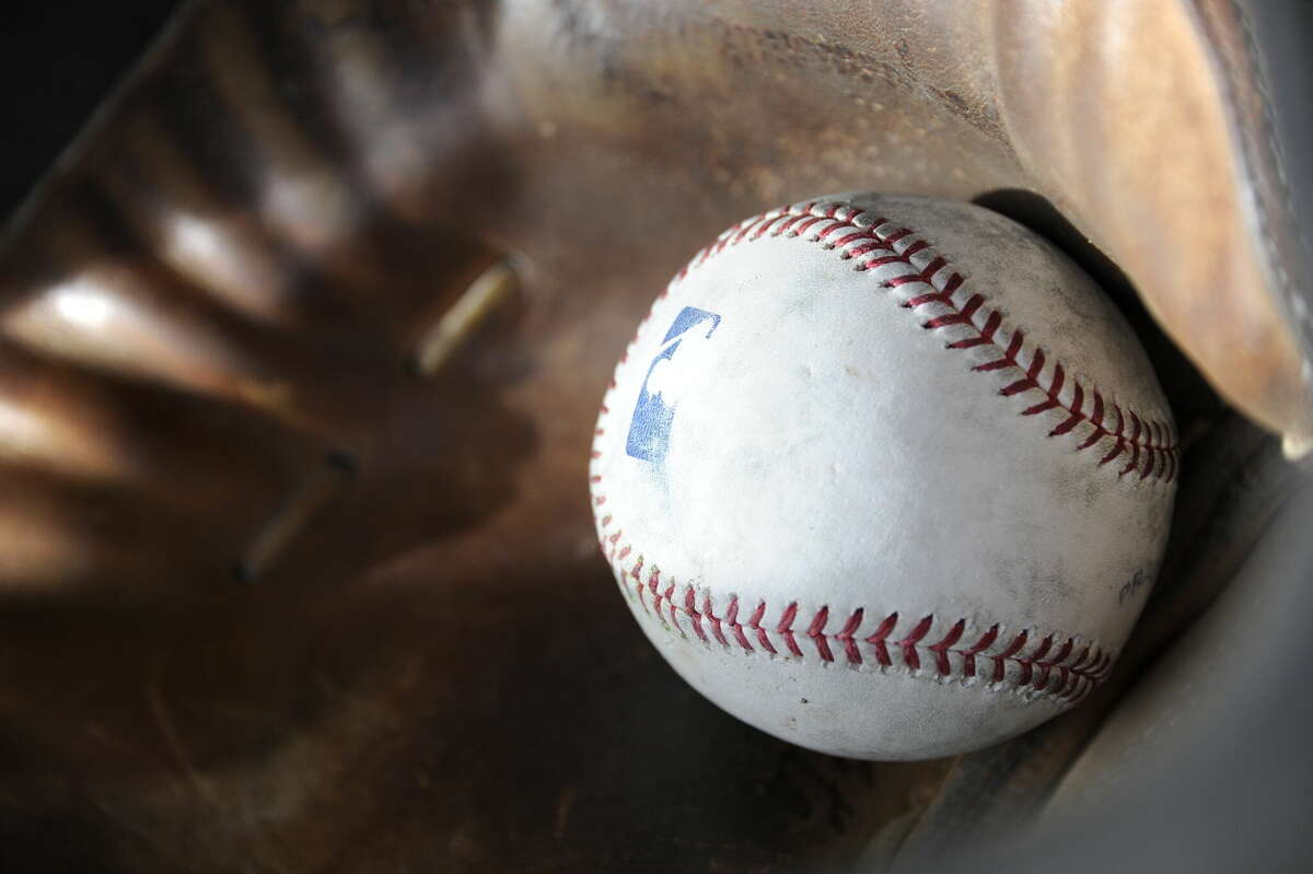 A batting practice baseball rests in a catchers mitt during Chicago White Sox spring training workouts on February 19, 2014 at The Ballpark at Camelback Ranch in Glendale, Arizona.