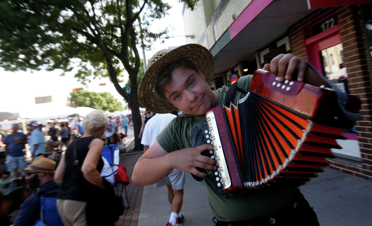 Devan Brandalick, 14 of New Braunfels, plays his accordion during the annual Wein & Saengerfest in downtown New Braunfels on Saturday, May 7, 2016. The teen said he wanted to keep bring cheer to the crowd after participating in the parade earlier in the day. 