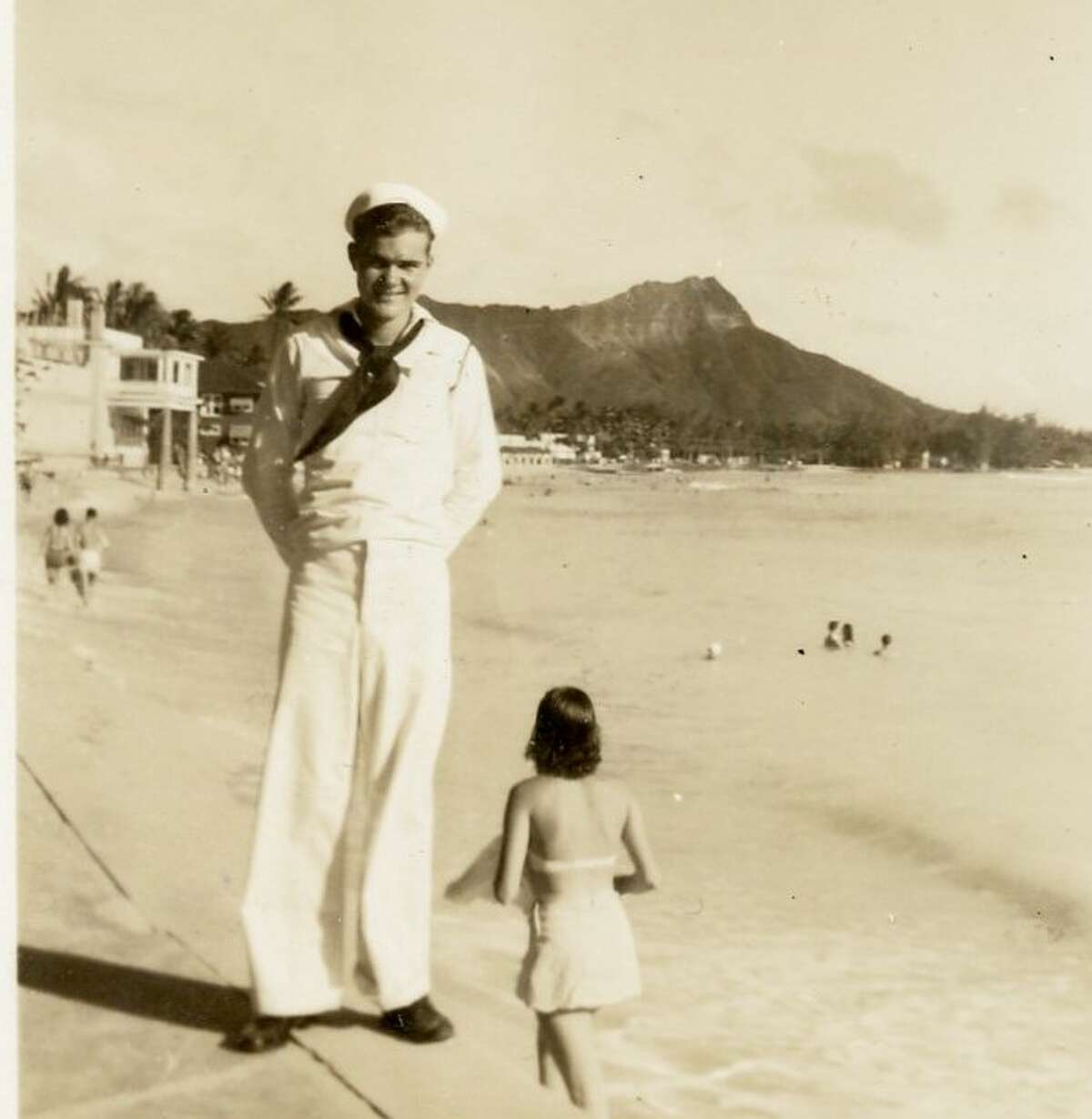 I looked at the photographs to discover a young sailor on leave on the beaches of Honolulu.